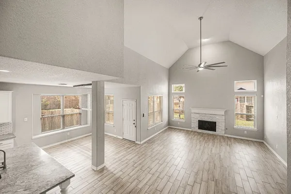 a large kitchen with stainless steel appliances granite countertop a lot of counter space and wooden floors