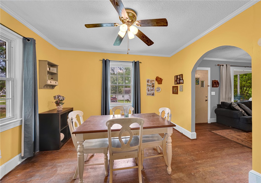 102 Graham Honea Path, SC 29654 - Photo 10 of 29 A well-lit dining area featuring a classic ceiling fan and an arched entryway.
