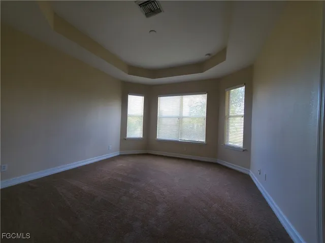 an empty room with a empty space and windows