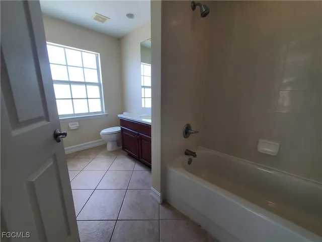 a bathroom with a bathtub and window