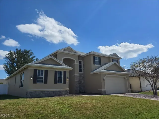 a front view of a house with a yard