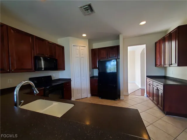 a kitchen with a refrigerator and a sink
