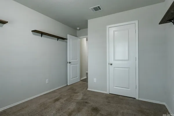 an empty room with closet area