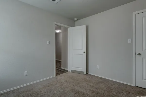 an empty room with closet area