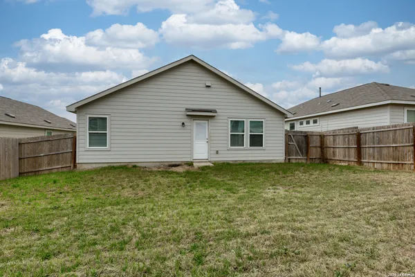 a backyard of a house with wooden fence