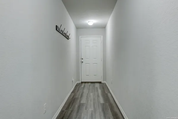 a view of a hallway with wooden floor