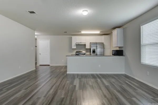 a view of cabinets and wooden floor