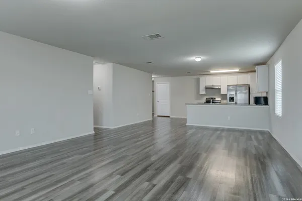 a view of a kitchen with a sink and wooden floor