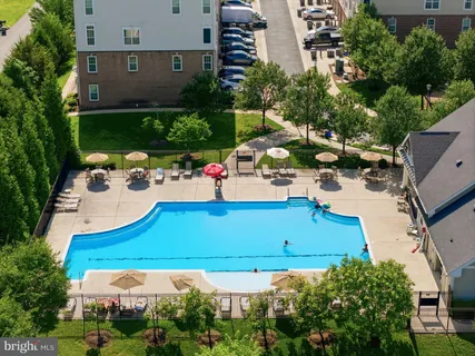 an aerial view of a house with yard swimming pool and outdoor seating