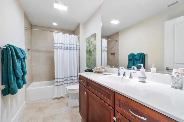 a bedroom with a bed wooden floor and window