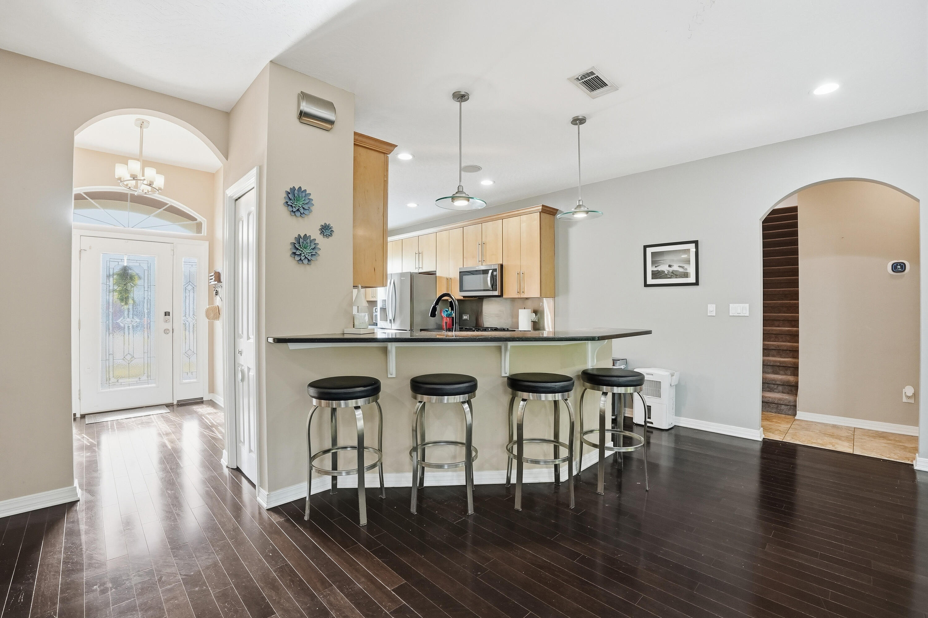 1961 Chesapeake Ridge Fort Walton Beach, FL 32547 - Photo 15 of 47 a kitchen with stainless steel appliances granite countertop a dining table chairs and granite counter tops