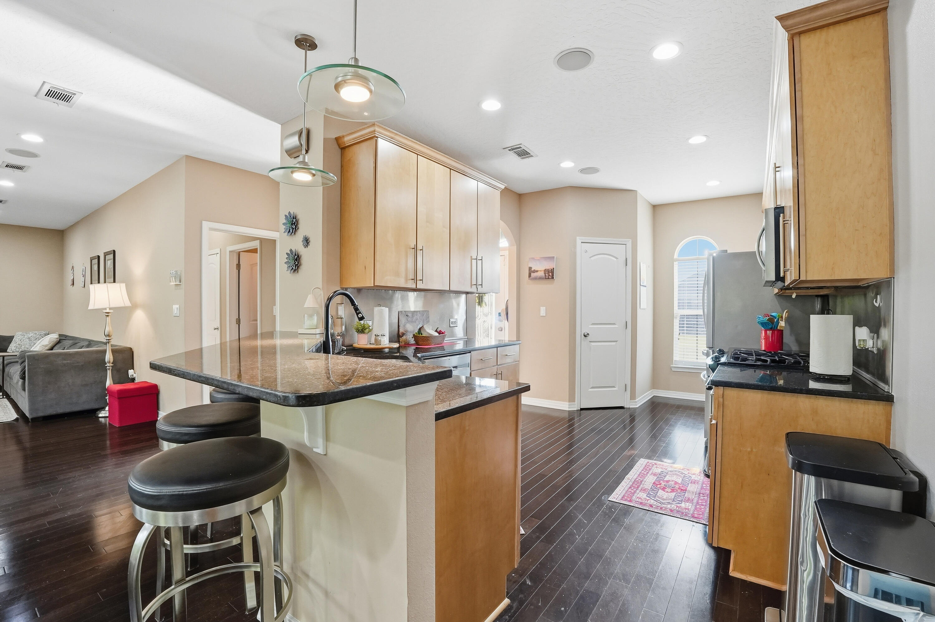 1961 Chesapeake Ridge Fort Walton Beach, FL 32547 - Photo 17 of 47 a kitchen with granite countertop kitchen island stainless steel appliances refrigerator dining table and chairs