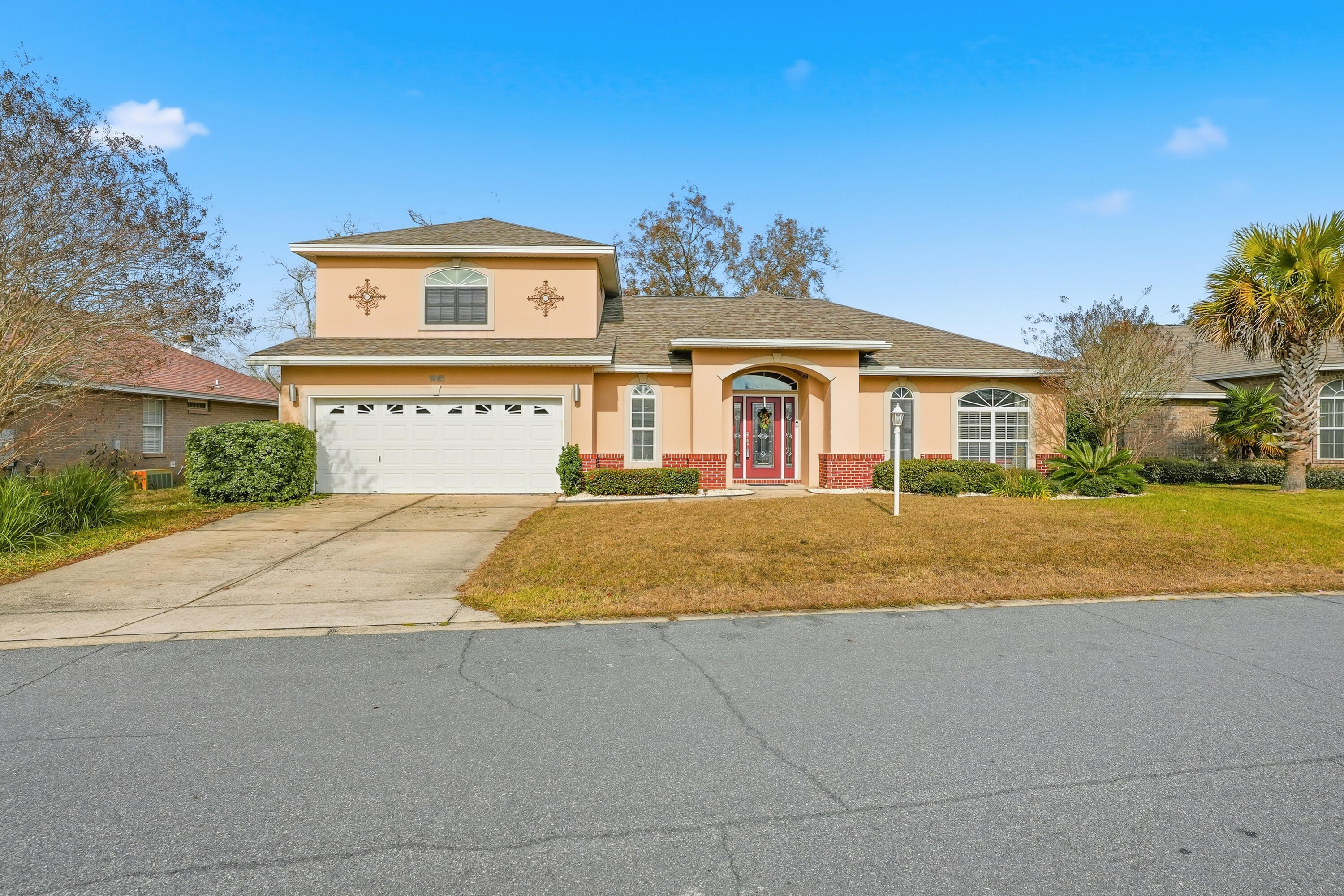 1961 Chesapeake Ridge Fort Walton Beach, FL 32547 - Photo 2 of 47 a front view of a house with a yard