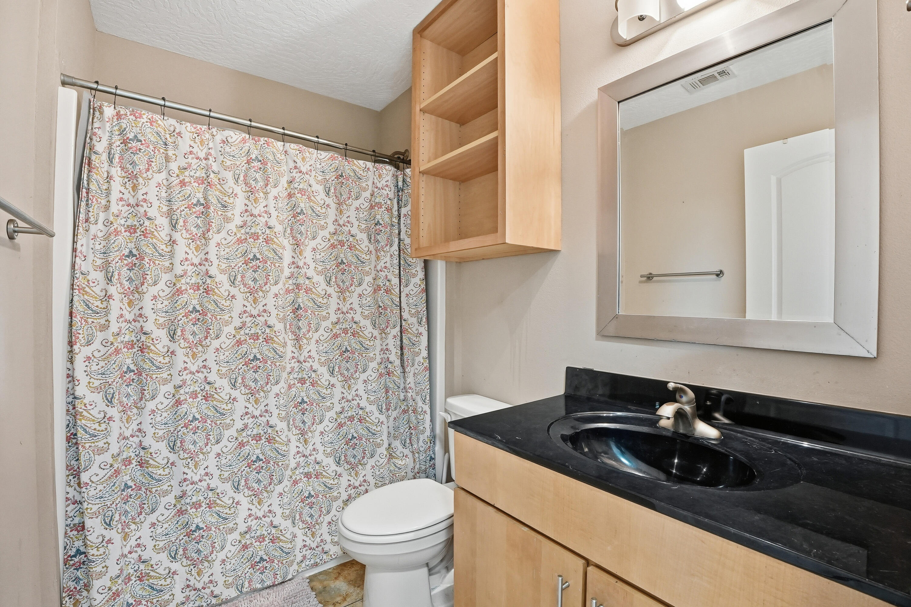 1961 Chesapeake Ridge Fort Walton Beach, FL 32547 - Photo 35 of 47 a sink and a toilet sitting next to a shower curtain