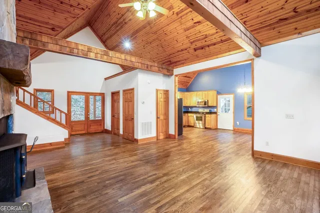 a kitchen with stainless steel appliances granite countertop a refrigerator a sink a stove and dishwasher