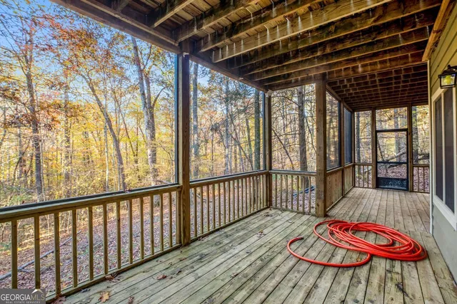 a view of a porch with wooden floor and stairs