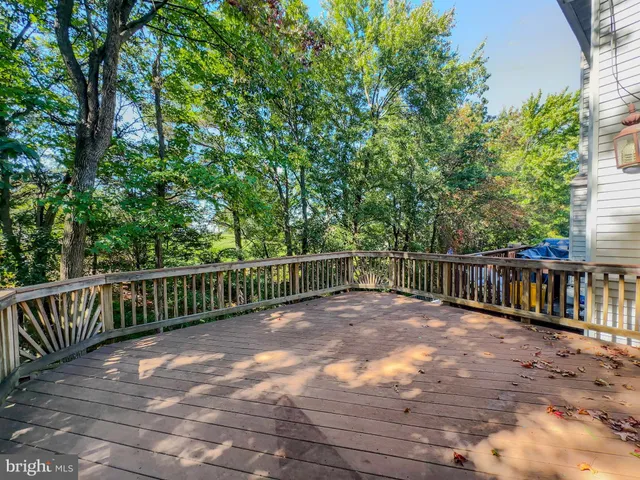 a view of balcony with wooden floor and fence