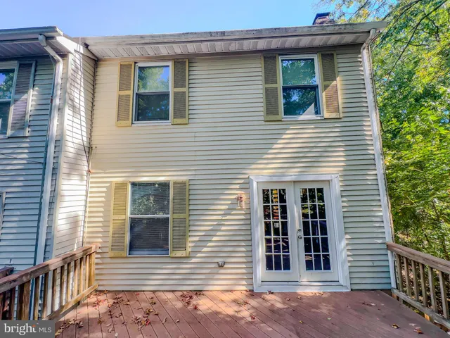 a view of a house with a window and wooden fence