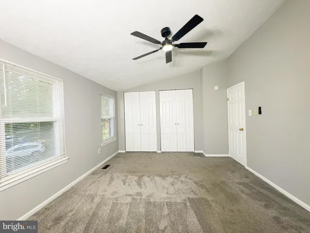 a view of a livingroom with a ceiling fan and window