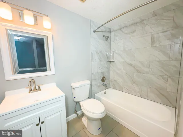 a bathroom with a sink a toilet and a bathtub