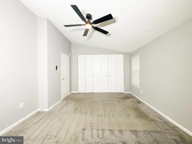 a view of a livingroom with a ceiling fan & a ceiling fan