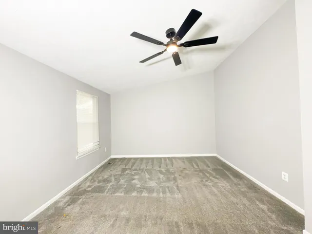 a view of a big room with wooden floor and windows in a room