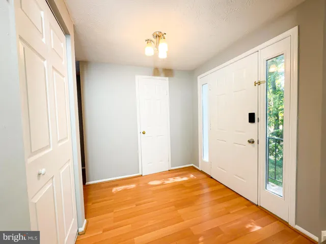a view of a bedroom with wooden floor and a window