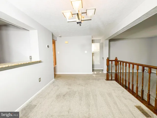 a view of a hallway with a chandelier