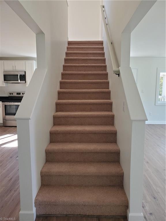 403 Calvin Sowers Road Lexington, NC 27295 - Photo 19 of 49 Stairway has been opened up so it doesn't feel so boxed in. Brand new carpet in all bedrooms, stairs and in sitting room/loft upstairs.