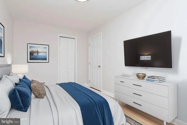 a bedroom with a bed and a flat screen tv