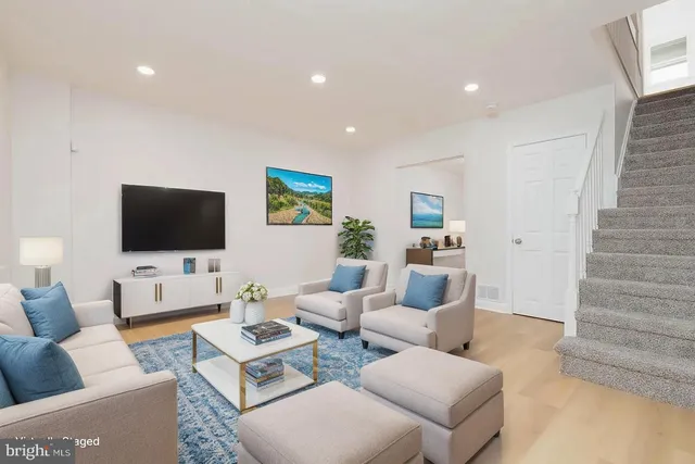 a living room with furniture and a flat screen tv