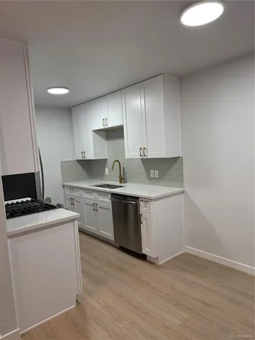 a kitchen with a stove a sink and a refrigerator