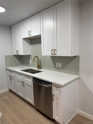 a kitchen with a sink and cabinets