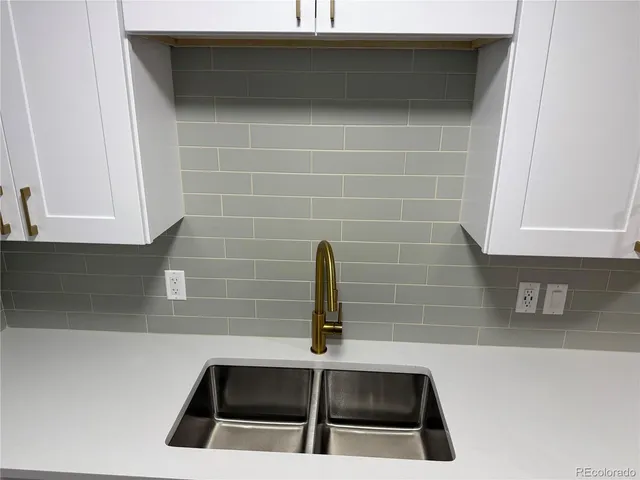 a kitchen with a stove a sink and a refrigerator