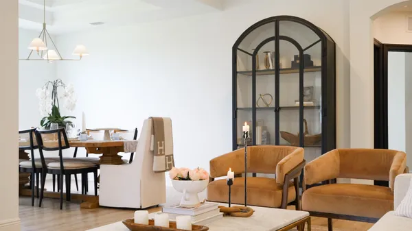 a living room with furniture a window and a chandelier