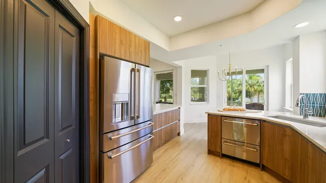 a large kitchen with granite countertop a sink and cabinets