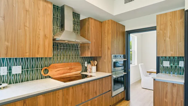 a kitchen with stainless steel appliances granite countertop a sink a stove and a refrigerator