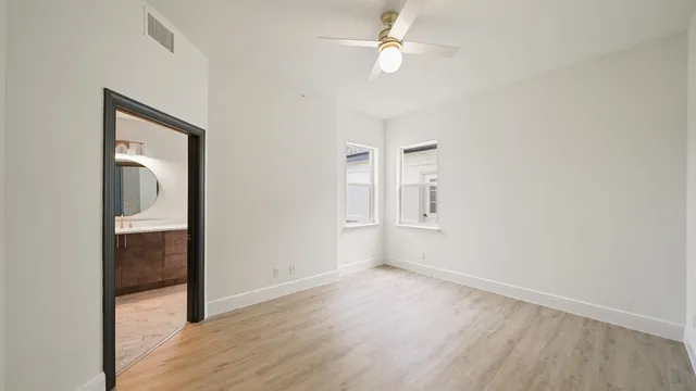 a view of a yard with porch and wooden fence