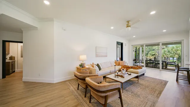 a living room with furniture fireplace and wooden floor