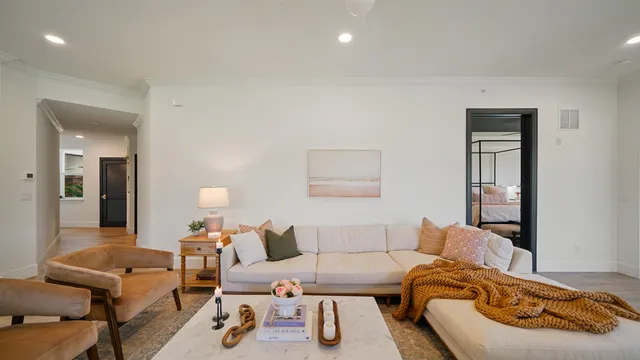 a view of a dining room with furniture a chandelier and wooden floor