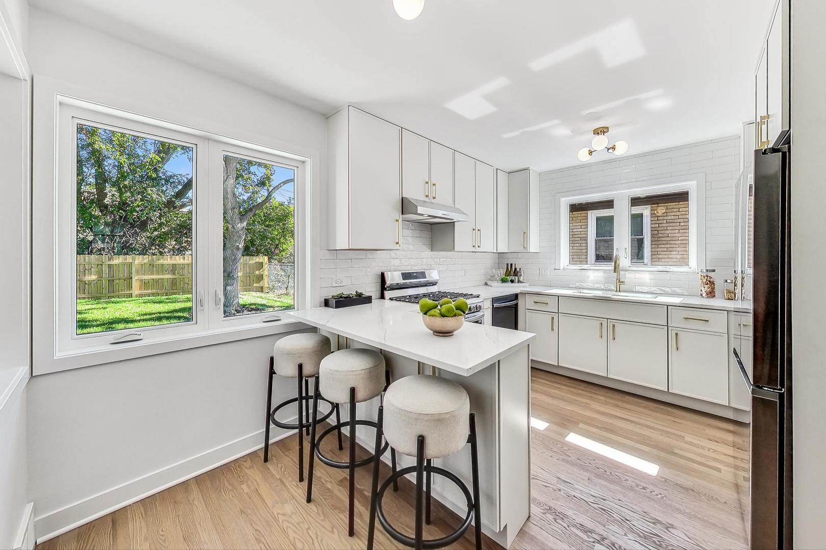 736 Selborne Road Riverside, IL 60546 - Photo 7 of 36 a kitchen with a sink window and cabinets