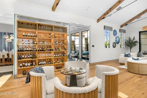 a living room with furniture a chandelier and kitchen view