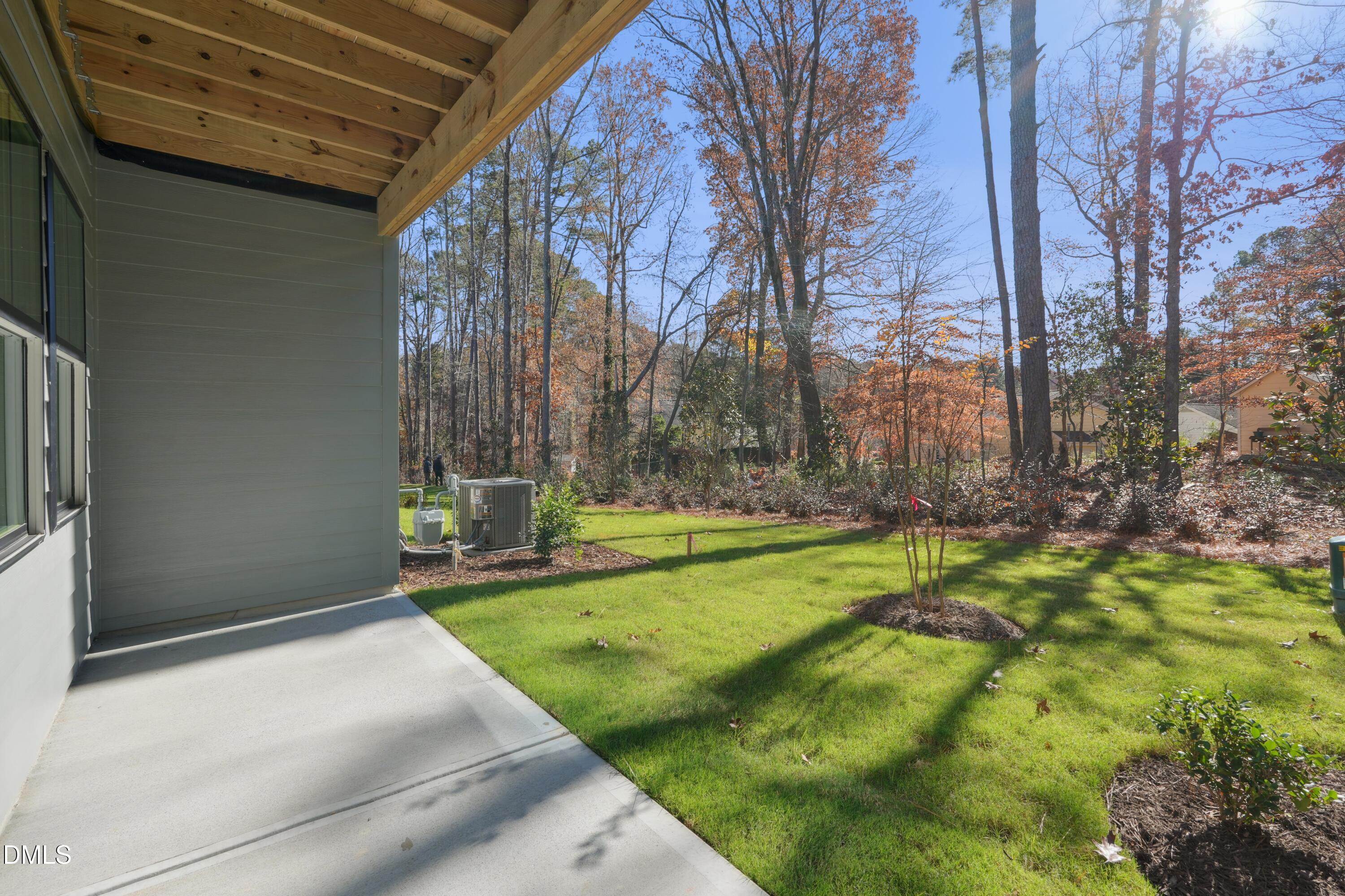4607 Mint Leaf Lane Raleigh, NC 27612 - Photo 2 of 17 a view of a backyard with table and chairs and a large tree