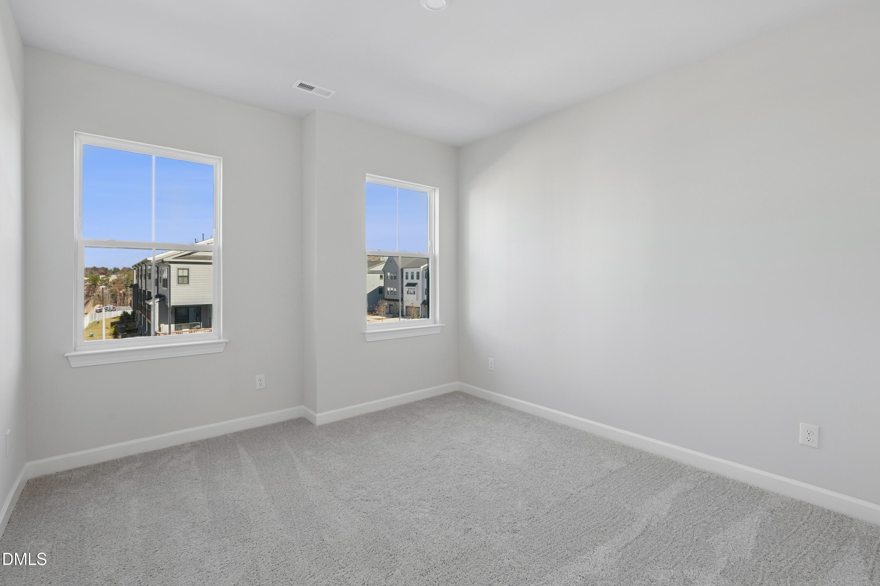 4607 Mint Leaf Lane Raleigh, NC 27612 - Photo 9 of 17 an empty room with windows