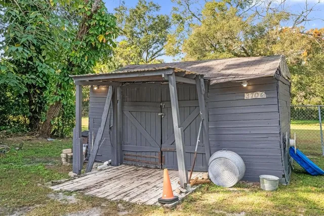 a backyard of a house with barbeque oven
