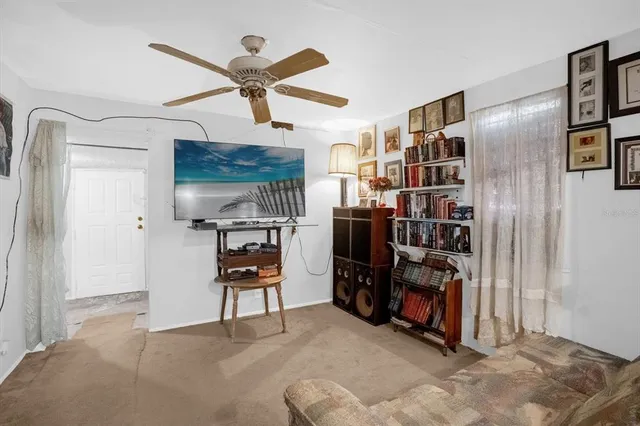 a view of a livingroom with furniture and staircase