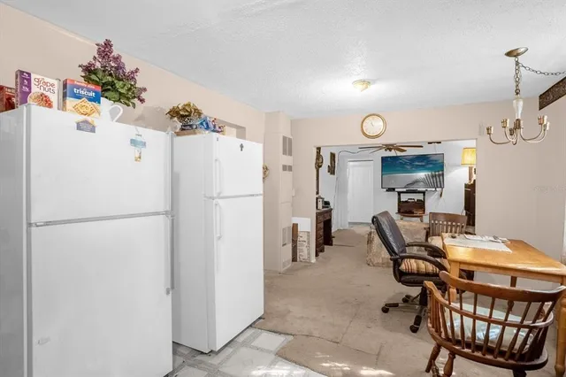 a white refrigerator freezer sitting in a kitchen
