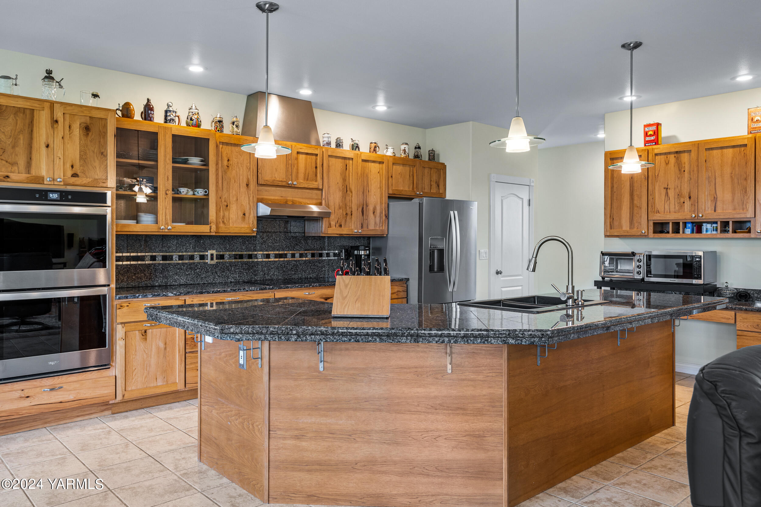 652 South Friedline Road Yakima, WA 98908 - Photo 15 of 38 a kitchen with stainless steel appliances granite countertop a sink a stove and a wooden cabinets