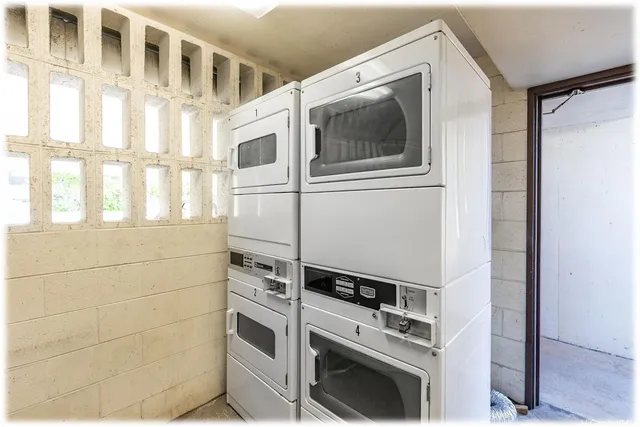 a kitchen with stainless steel appliances granite countertop a refrigerator a sink and a stove