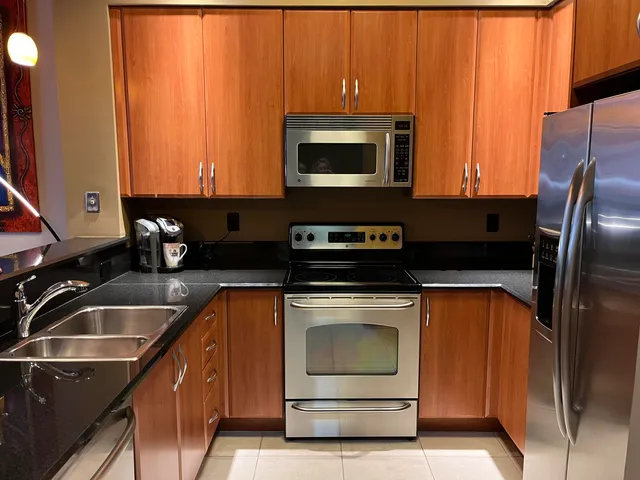 a kitchen with a sink a microwave a stove and refrigerator